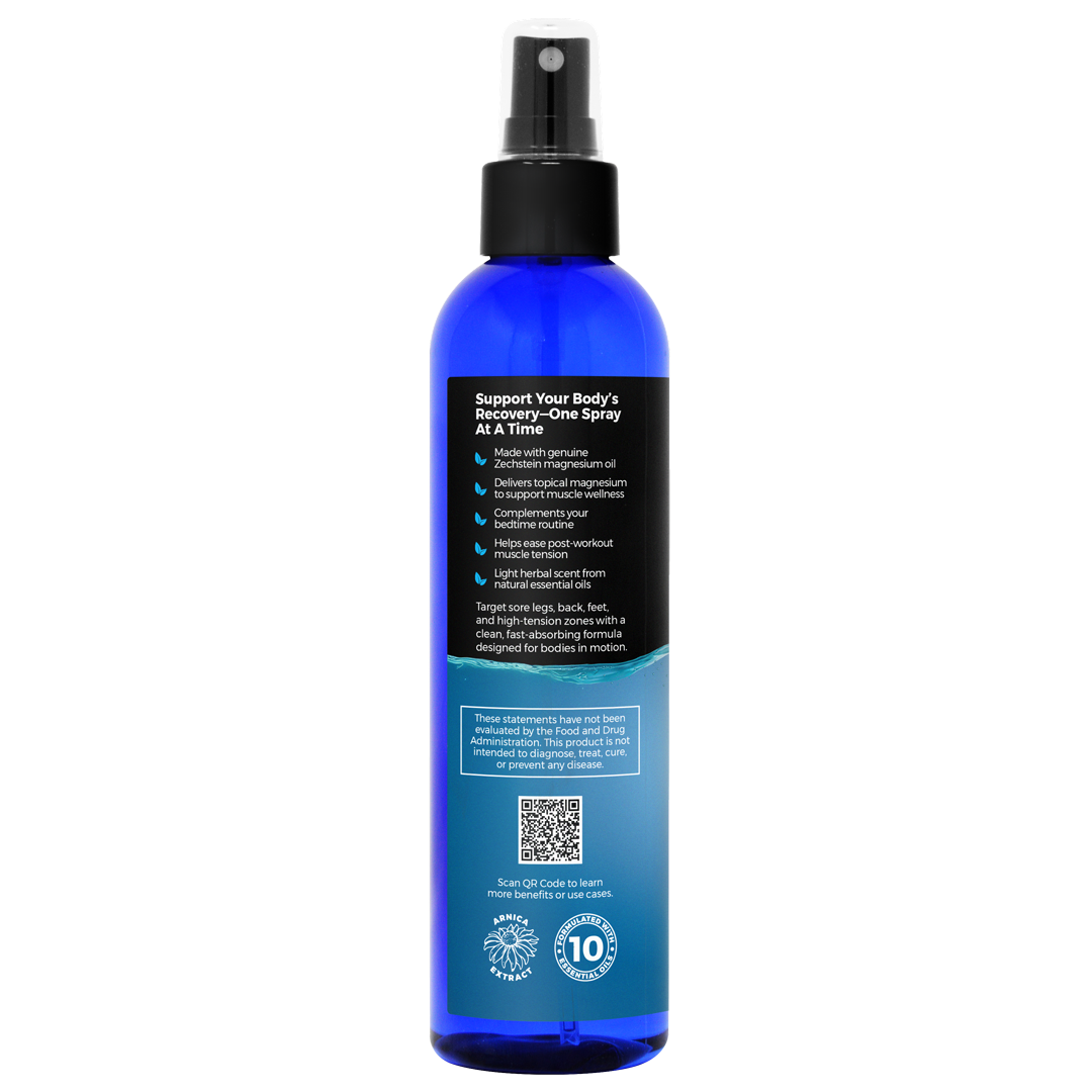 Blue spray bottle with black nozzle on a white background with useage recommendations for muscle rehab magnesium recovery spray with arnica and essential oils