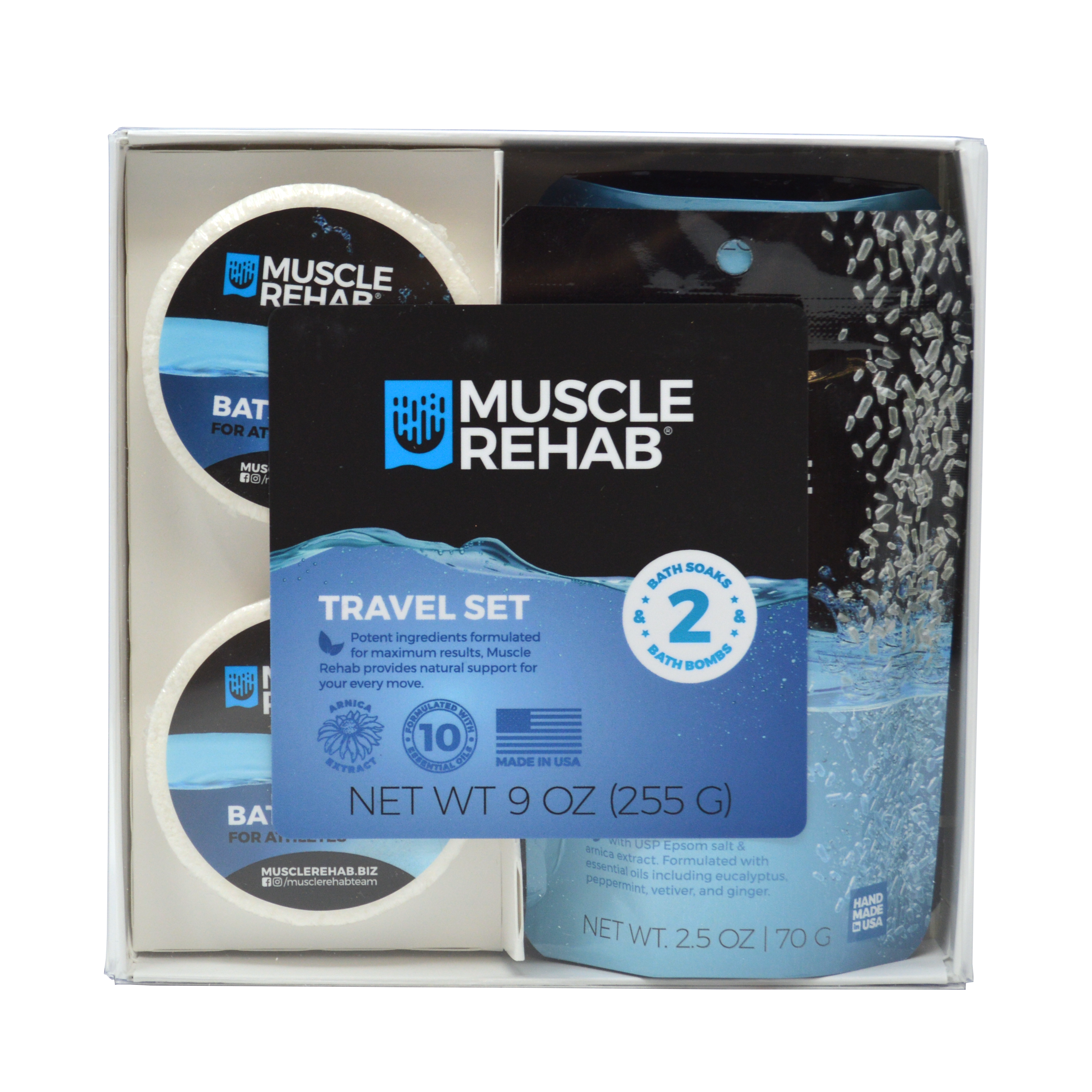 This image shows the front of the Muscle Rehab® Travel Set packaging.
Details on the front label:
Contents: 2 bath soaks & 2 bath bombs
Net Weight: 9 oz (255 g) total — individual bath soaks are 2.5 oz each
Claims:
Potent ingredients formulated for maximum results
Natural support for every move
Formulated with 10 essential oils
Made in the USA
Black and blue Muscle Rehab branding
Water splash and salt crystal imagery
Product window showing actual bath bombs and soak pouches inside