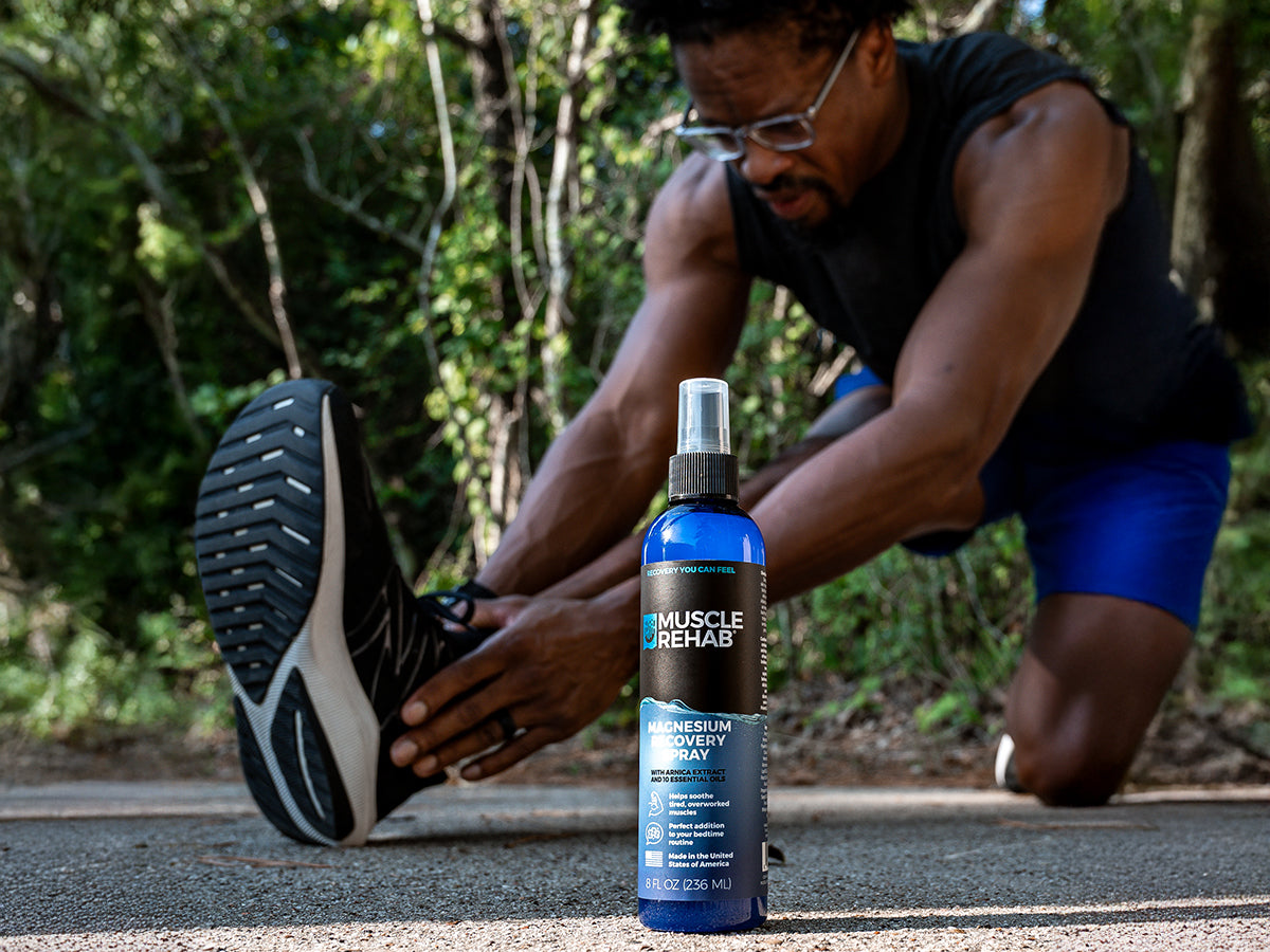 Muscle Rehab Magnesium Recovery Spray with athlete stretching outdoors after workout.